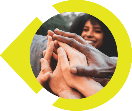 Group of people putting hands together.