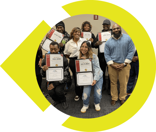 Group of people standing and smiling for picture with completed certificates.