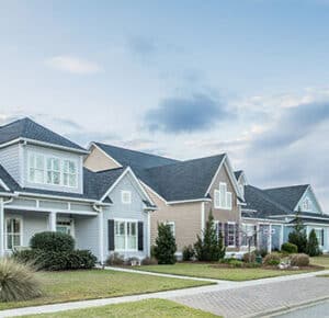 Row of houses with well landscaped front yards.