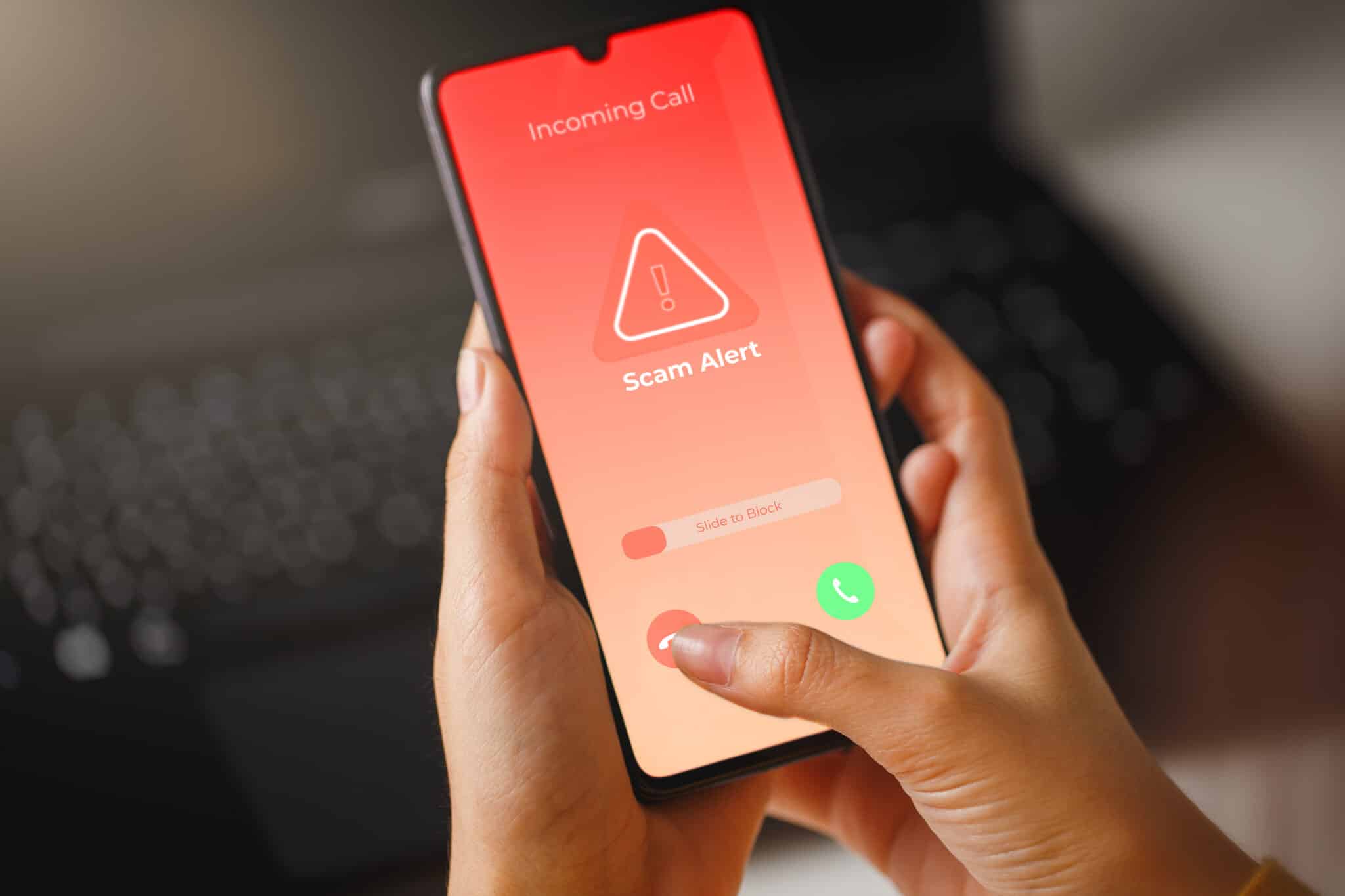Smartphone screen displays "Incoming Call" and "Scam Alert" with options to answer, decline, or slide to block